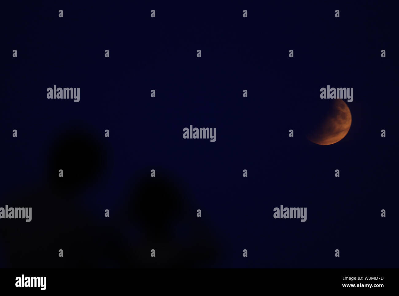 A partial lunar eclipse is visible above London from Primrose Hill, on ...
