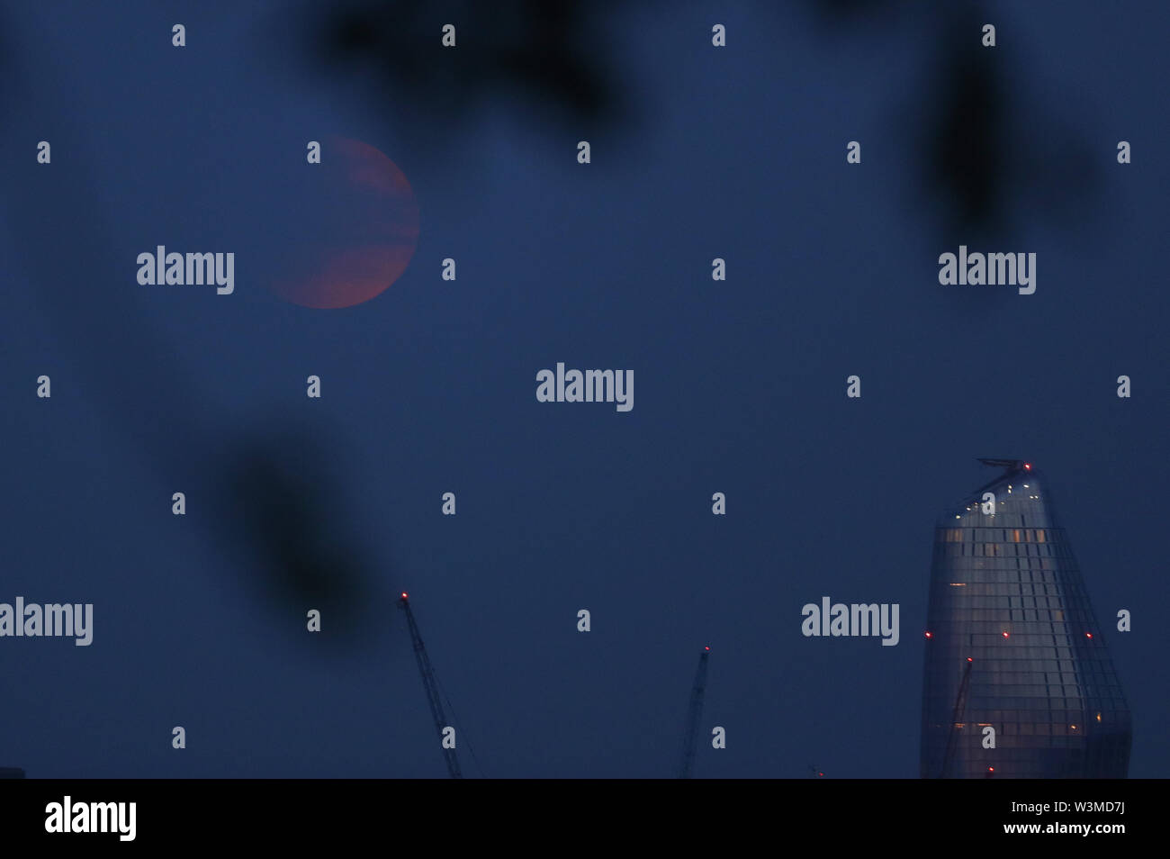 A partial lunar eclipse is visible above London from Primrose Hill, on ...