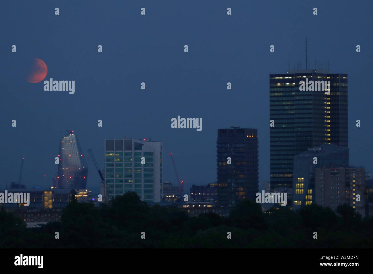 A partial lunar eclipse is visible above London from Primrose Hill, on ...