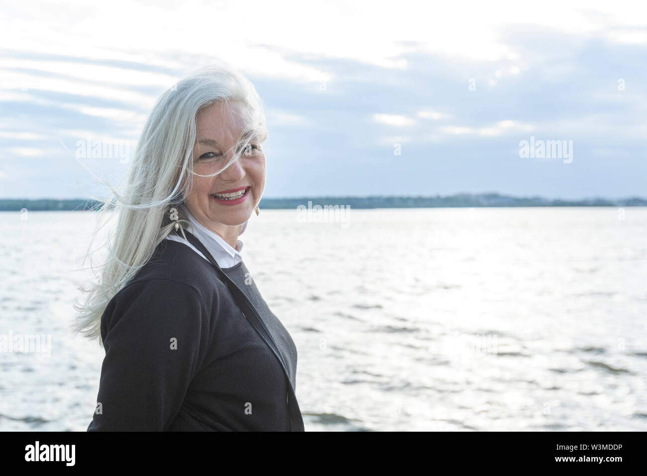 Smiling mature woman by Potomac River in Washington DC, USA Stock Photo
