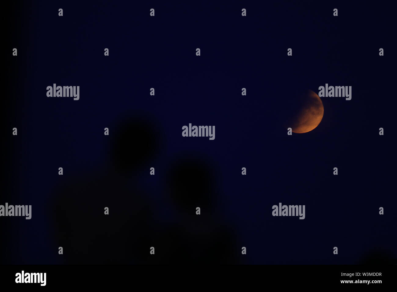 A partial lunar eclipse is visible above London from Primrose Hill, on ...