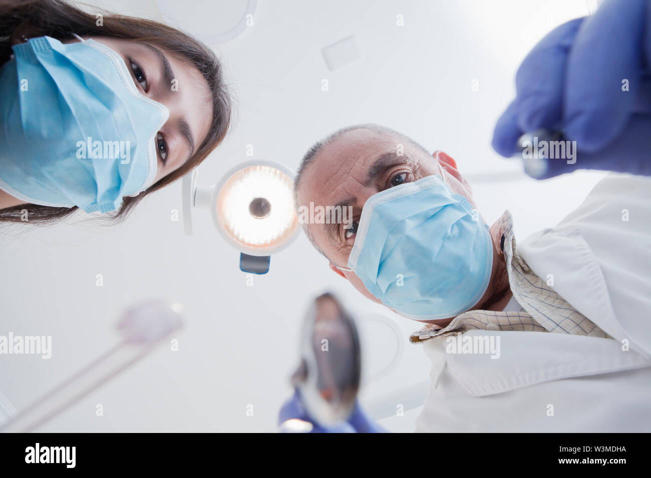View directly below dental hygienist and dentist during examination Stock Photo