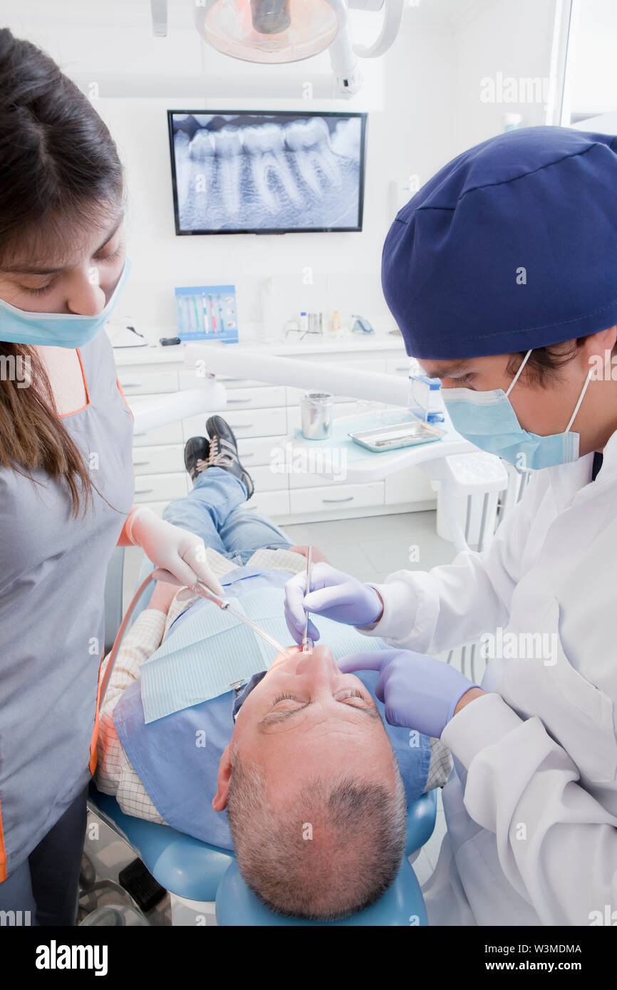 Dentist and hygienist cleaning patient's teeth Stock Photo Alamy