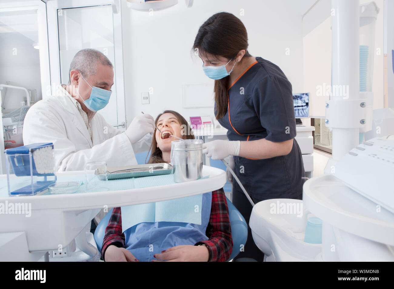 Dentist and hygienist cleaning patient's teeth Stock Photo Alamy