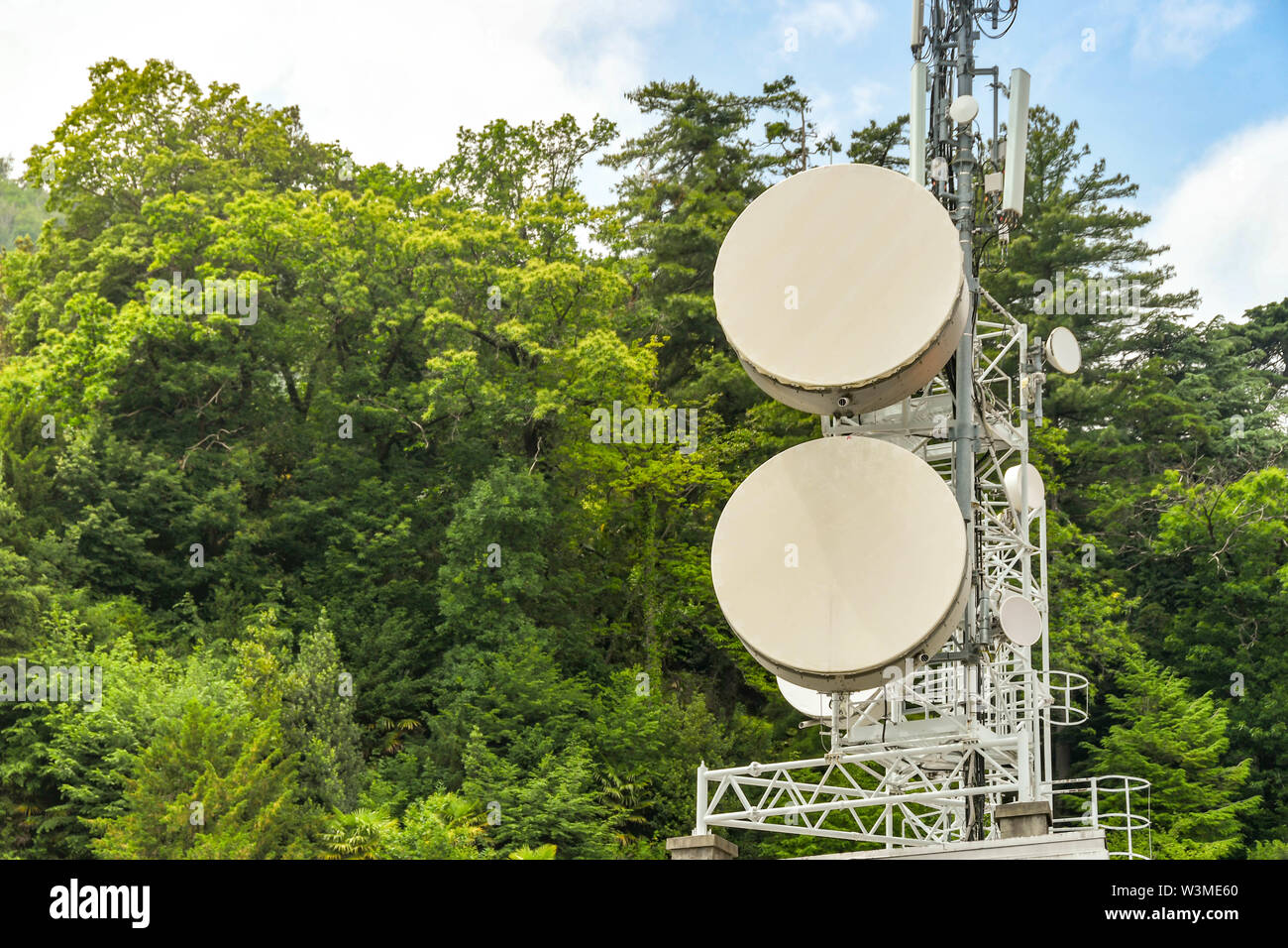 MENAGGIO, LAKE COMO, ITALY - JUNE 2019: Mobile phone communications mast and technology on top of a building in Menaggio on Lake Como Stock Photo