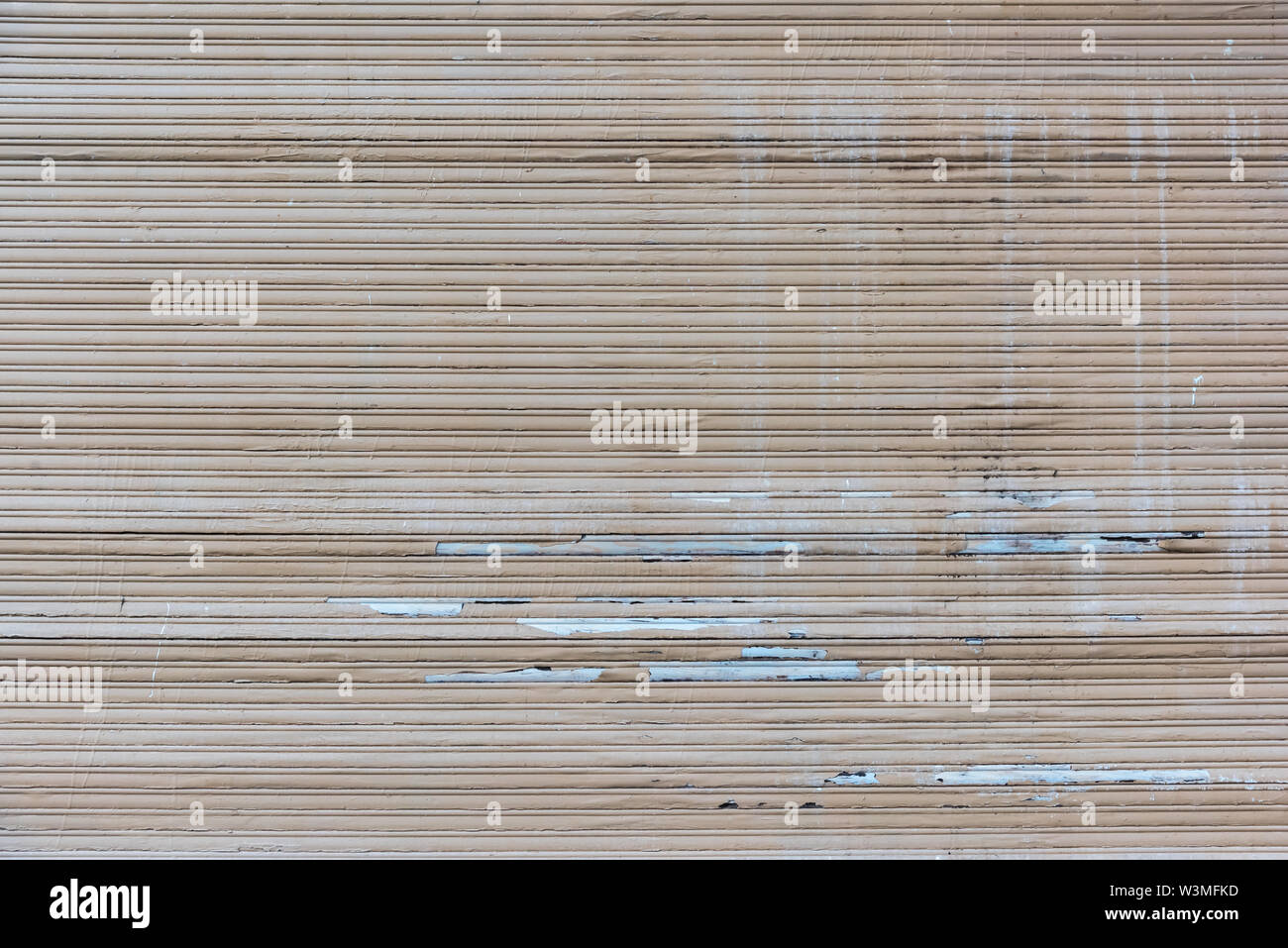 A old closed broken brown roller shutter Stock Photo
