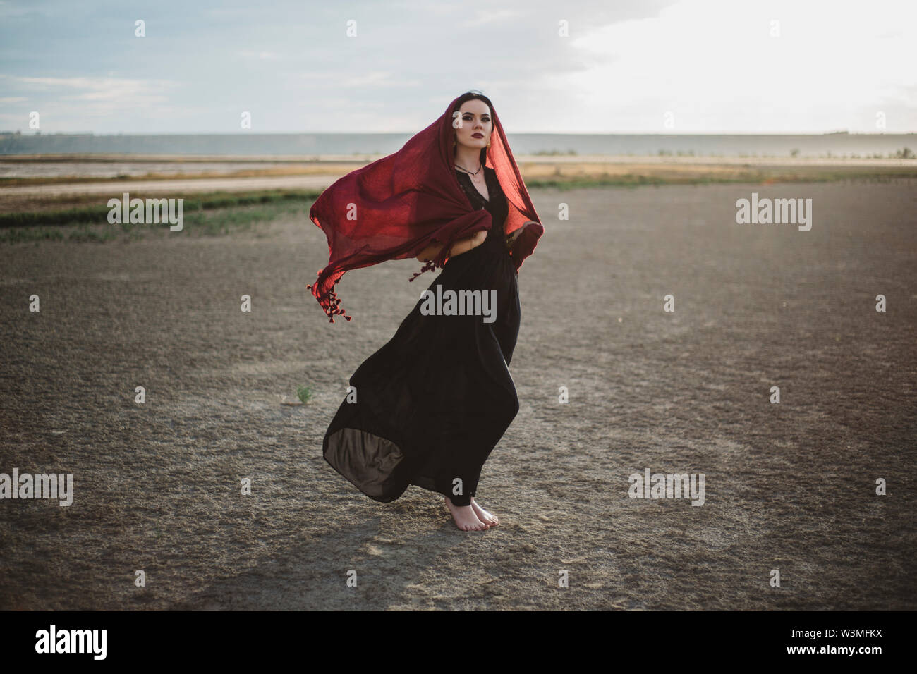 Windswept woman wearing red headscarf Stock Photo