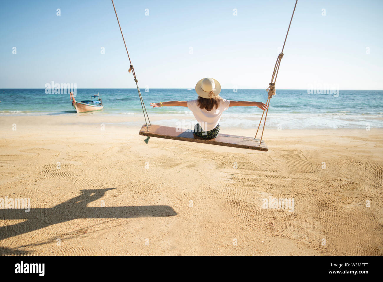 Woman on beach and swing hi-res stock photography and images - Alamy