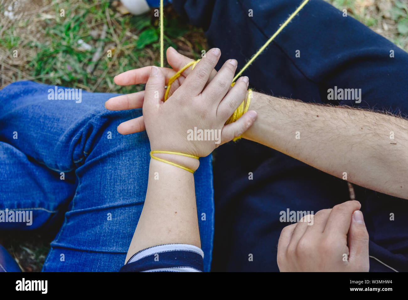 Two people with disabled Down syndrome holding hands. Stock Photo