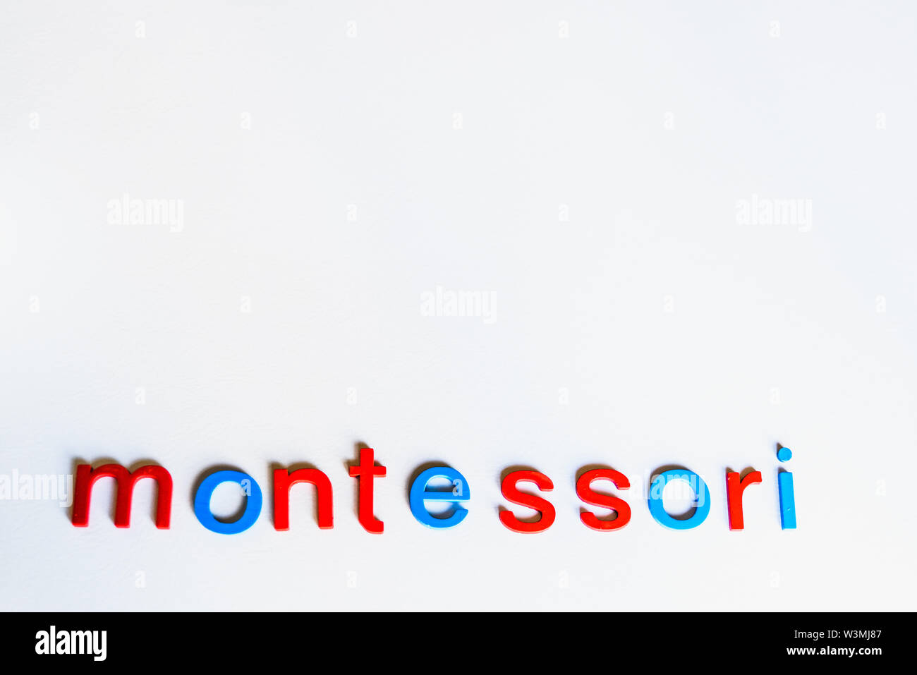 Montessori word written with colorful letters on white background Stock