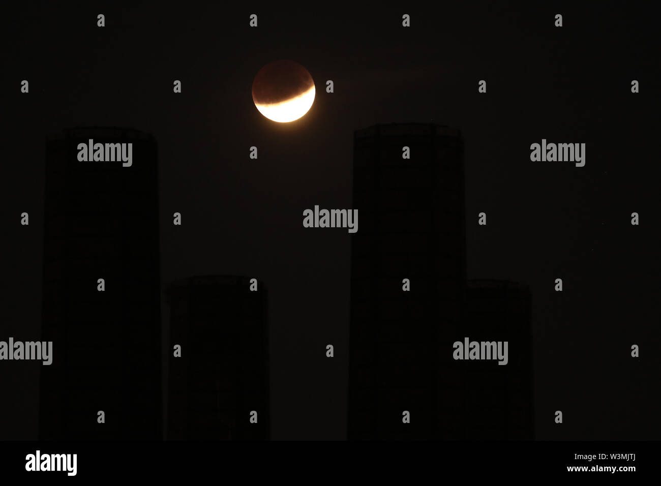 A partial lunar eclipse is visible above Greenwich, London, on the 50th ...