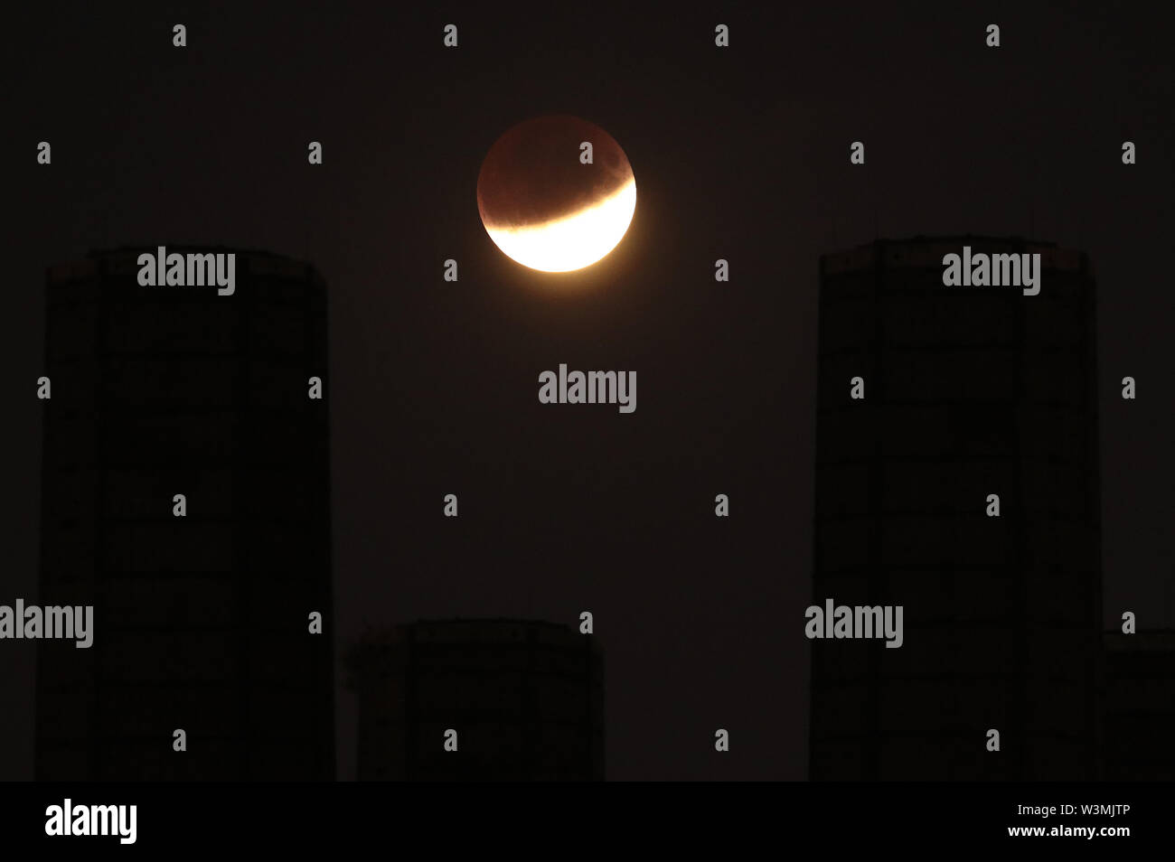 A partial lunar eclipse is visible above Greenwich, London, on the 50th ...