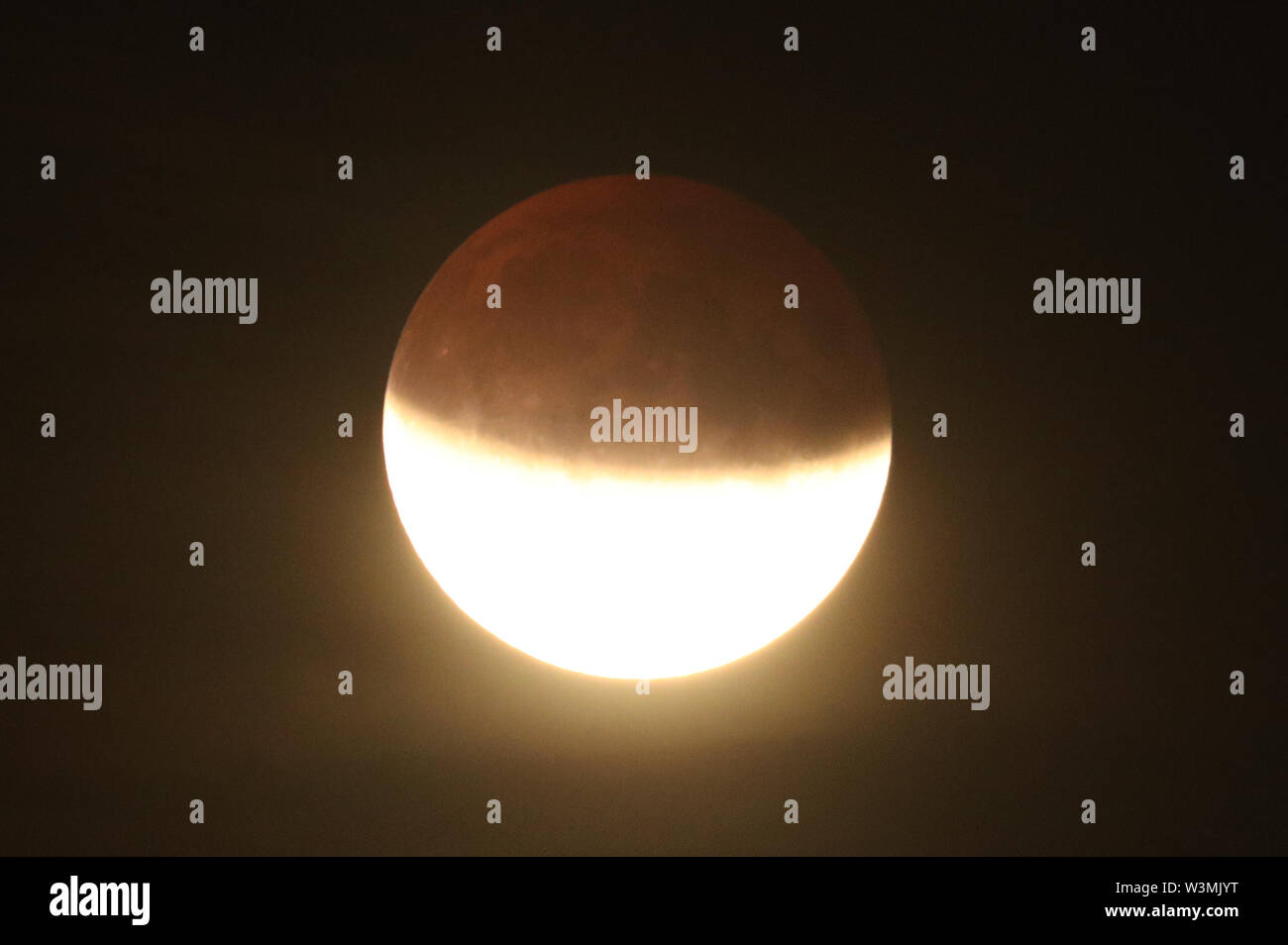 A partial lunar eclipse is visible above Greenwich, London, on the 50th ...