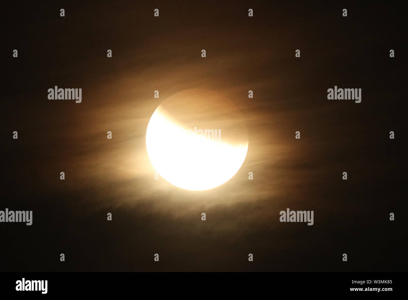 A partial lunar eclipse is visible above Greenwich, London, on the 50th ...