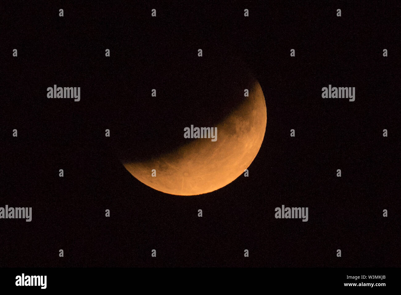 London, UK. 16 July 2019. A partial lunar eclipse takes place, as seen ...