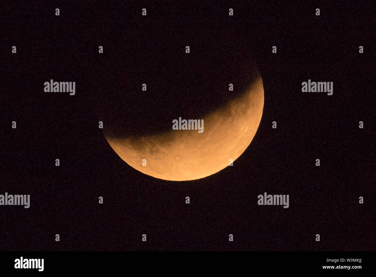 London, UK. 16 July 2019. A partial lunar eclipse takes place, as seen ...