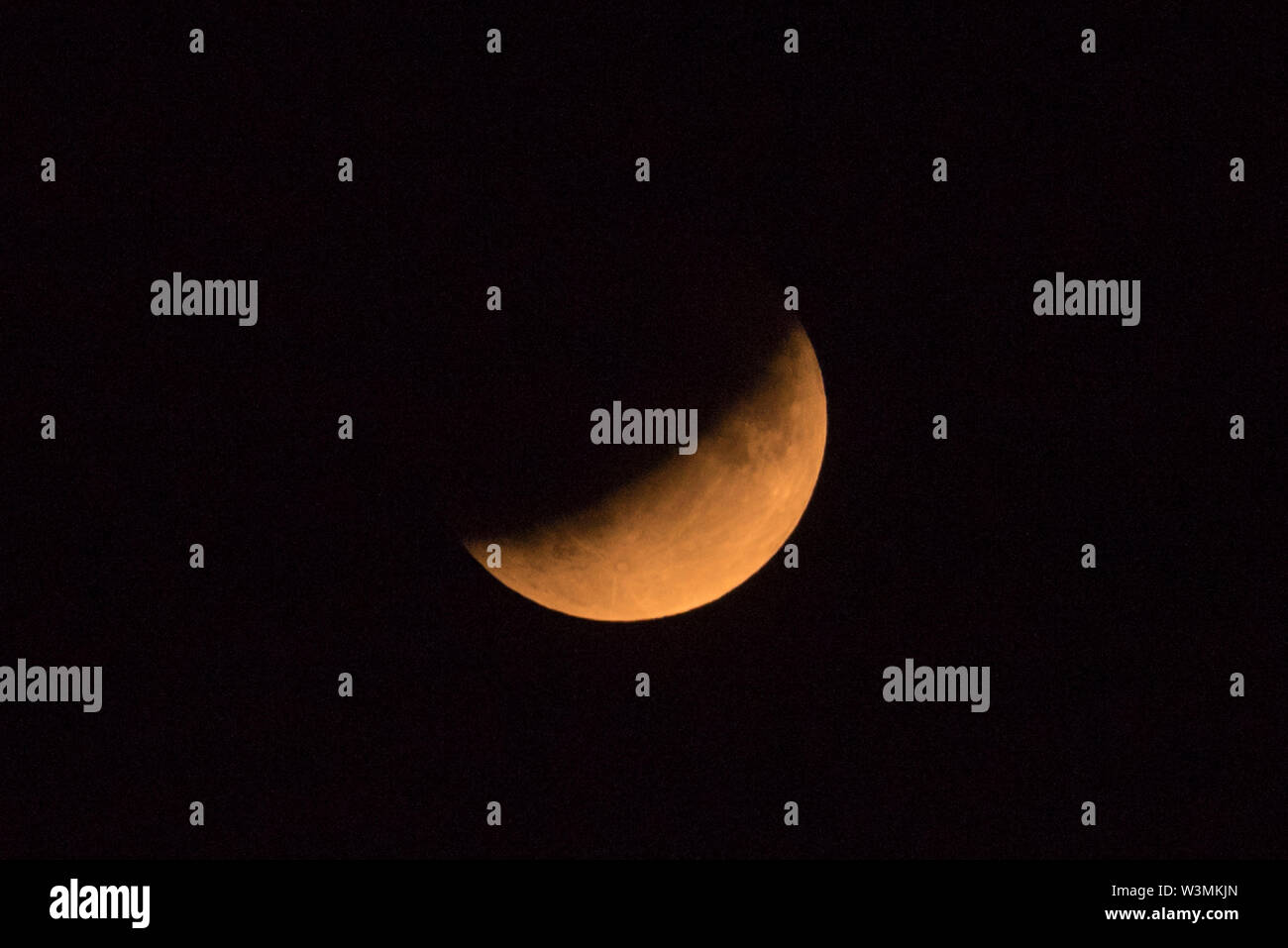 London, UK. 16 July 2019. A partial lunar eclipse takes place, as seen ...