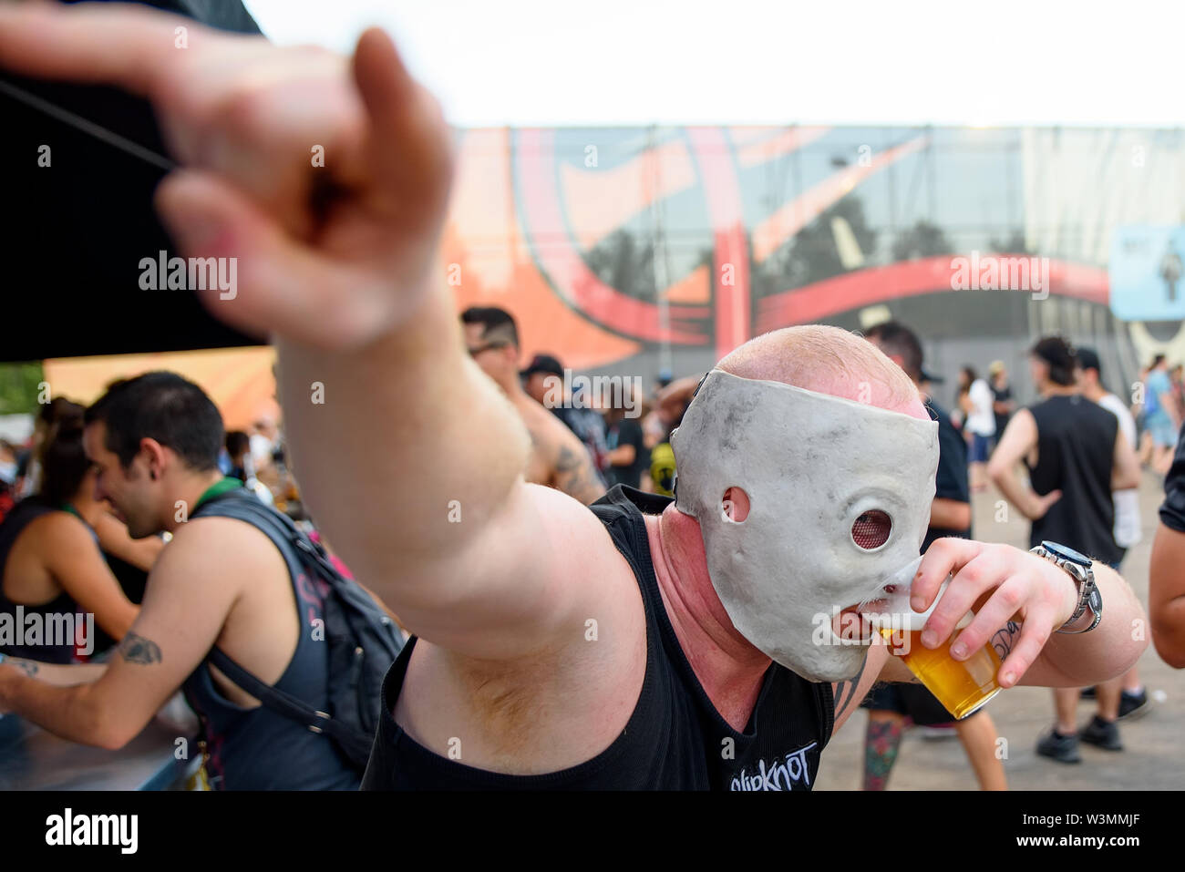 MADRID - JUN 30: A fan with the Slipknot mask drinks beer in a concert at Download (heavy metal music festival) on June 30, 2019 in Madrid, Spain. Stock Photo