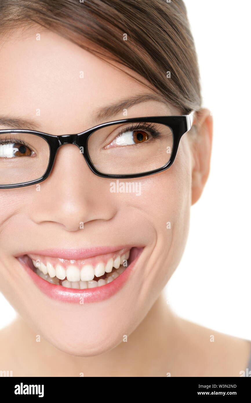 Glasses eyewear spectacles woman looking happy to side with big smile wearing eyeglasses. Close up portrait of female model face isolated on white background. Mixed race Asian Caucasian female model. Stock Photo