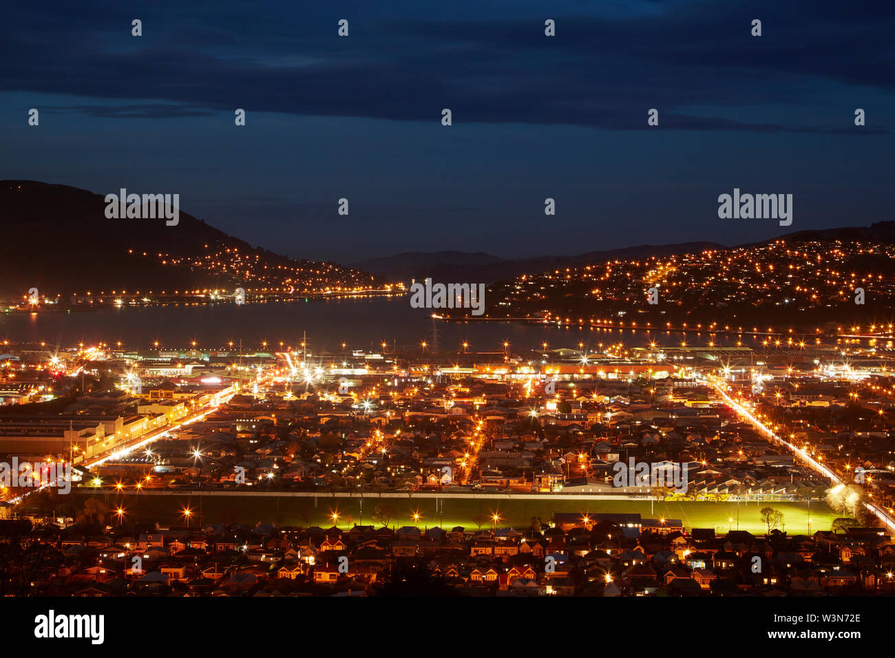 City lights, South Dunedin and Otago Harbour, Dunedin, South Island, New Zealand Stock Photo