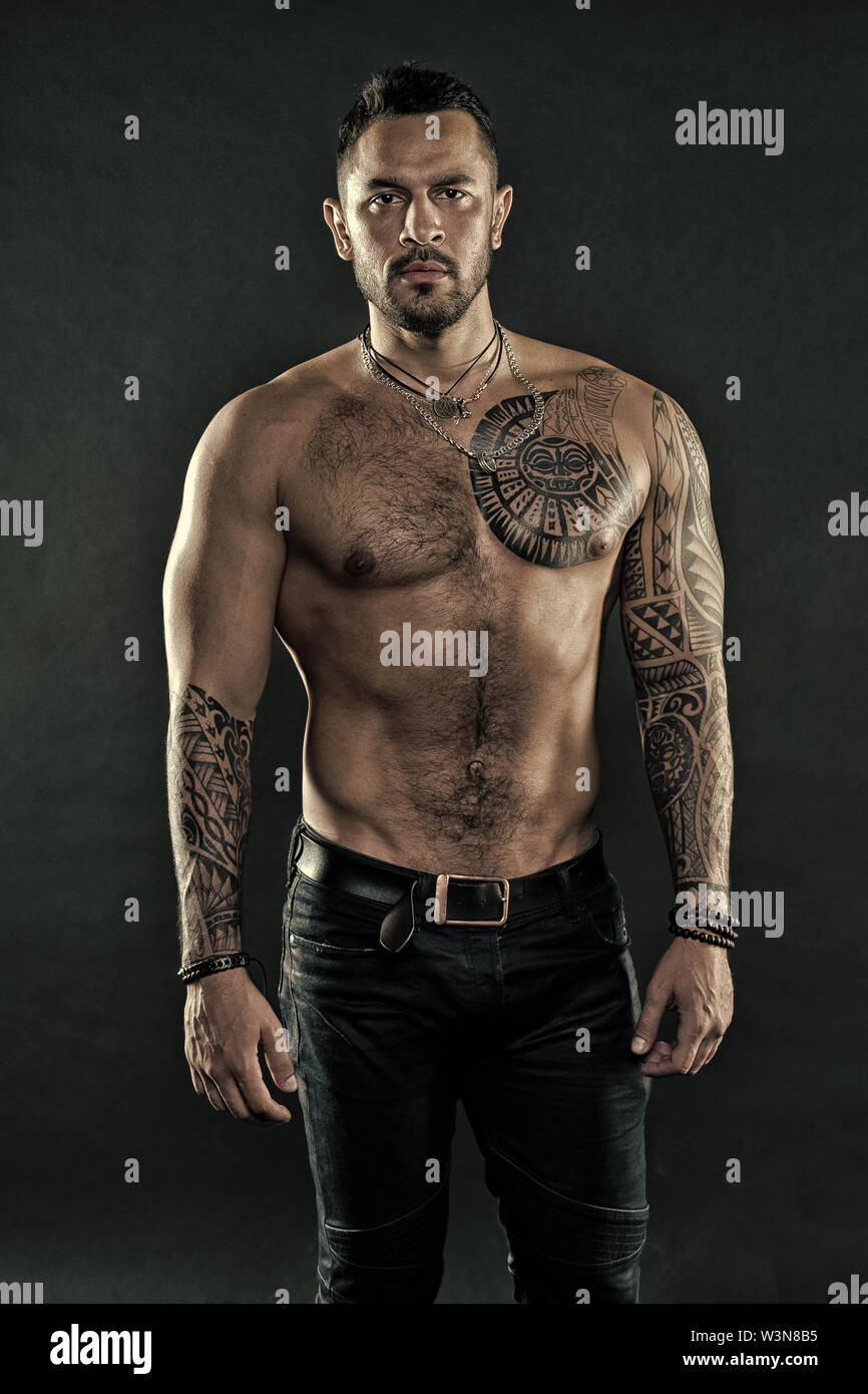 Brutal strict macho with tattoos. Masculinity and brutality. Tattoo culture  concept. Tattoo brutal attribute. Man brutal unshaven hispanic appearance  tattooed arms. Bearded man show tattooed torso Stock Photo - Alamy