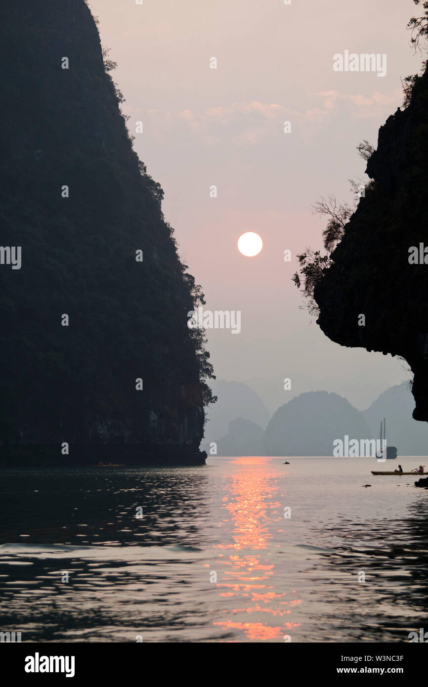 Ha Long Bay in Vietnam  is a UNESCO World Heritage Site and a part of Quang Ninh Province. Hạ Long means 'descending dragon'. The bay belongs to Ha Lo Stock Photo