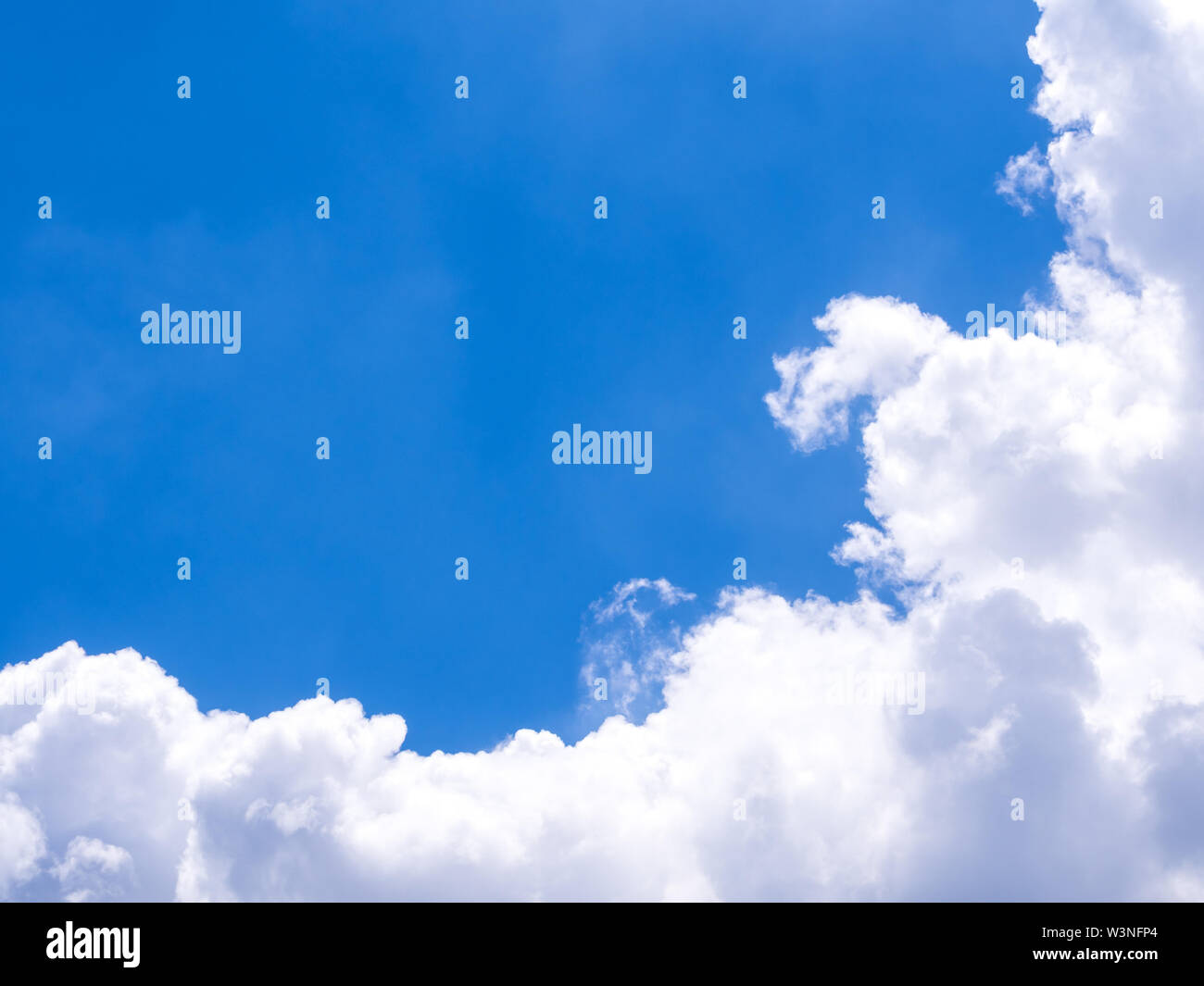Fluffy clouds in the bright blue sky Stock Photo - Alamy