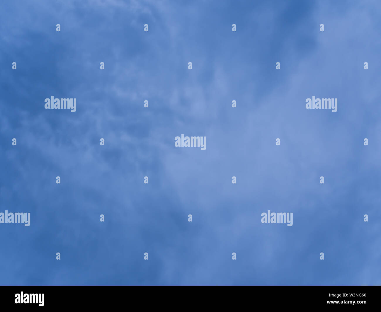 Fluffy clouds in the bright blue sky Stock Photo - Alamy