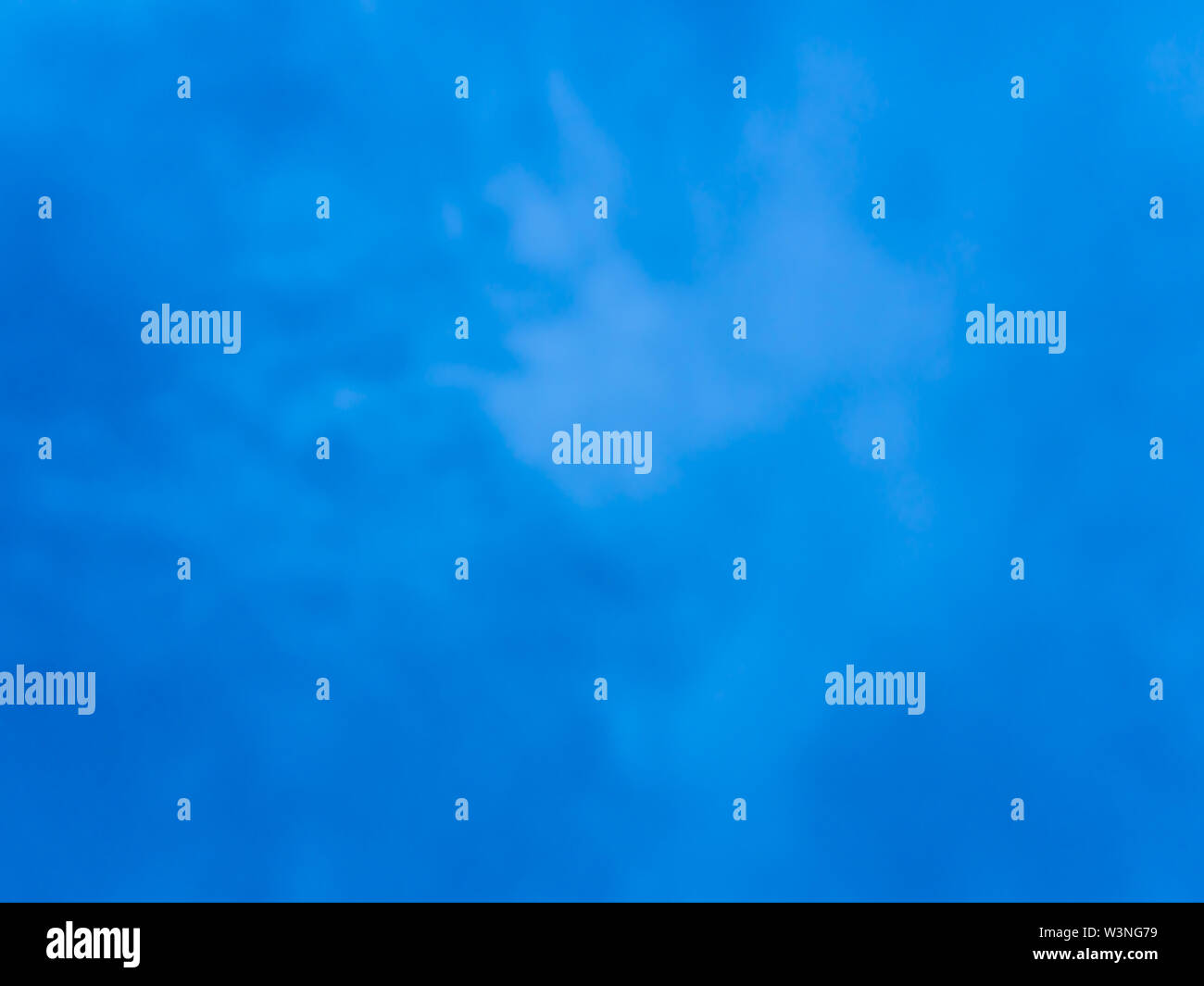 Fluffy clouds in the bright blue sky Stock Photo - Alamy