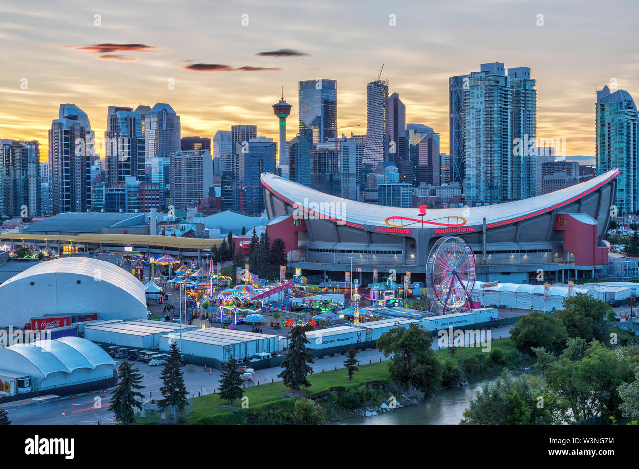 CALGARY, CANADA - JULY 14, 2019: Sunset over Calgary skyline with the annual Stampede event at the Saddledome grounds. The Calgary Stampede is renowne Stock Photo
