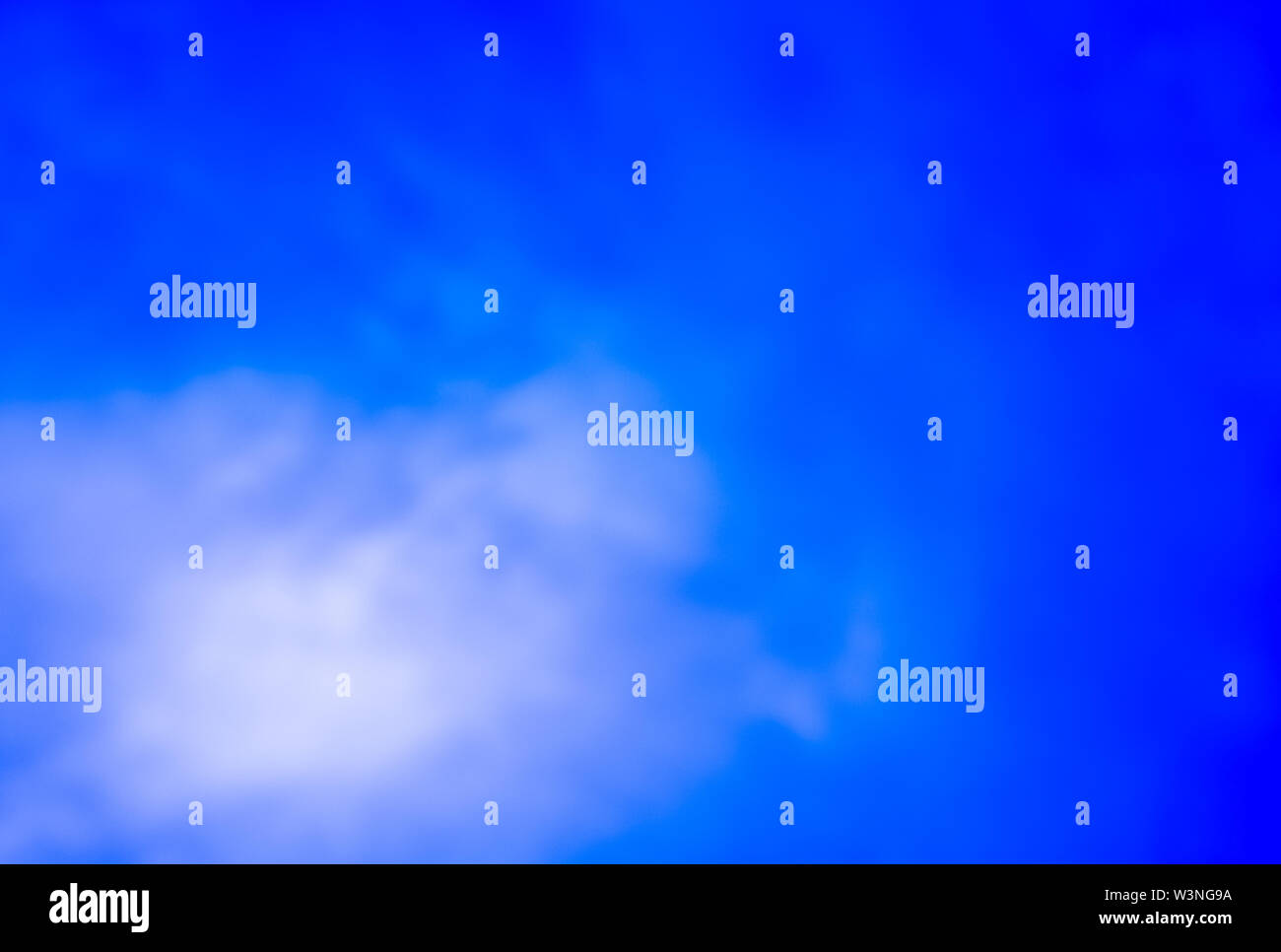 fluffy blur clouds in the bright blue sky Stock Photo - Alamy