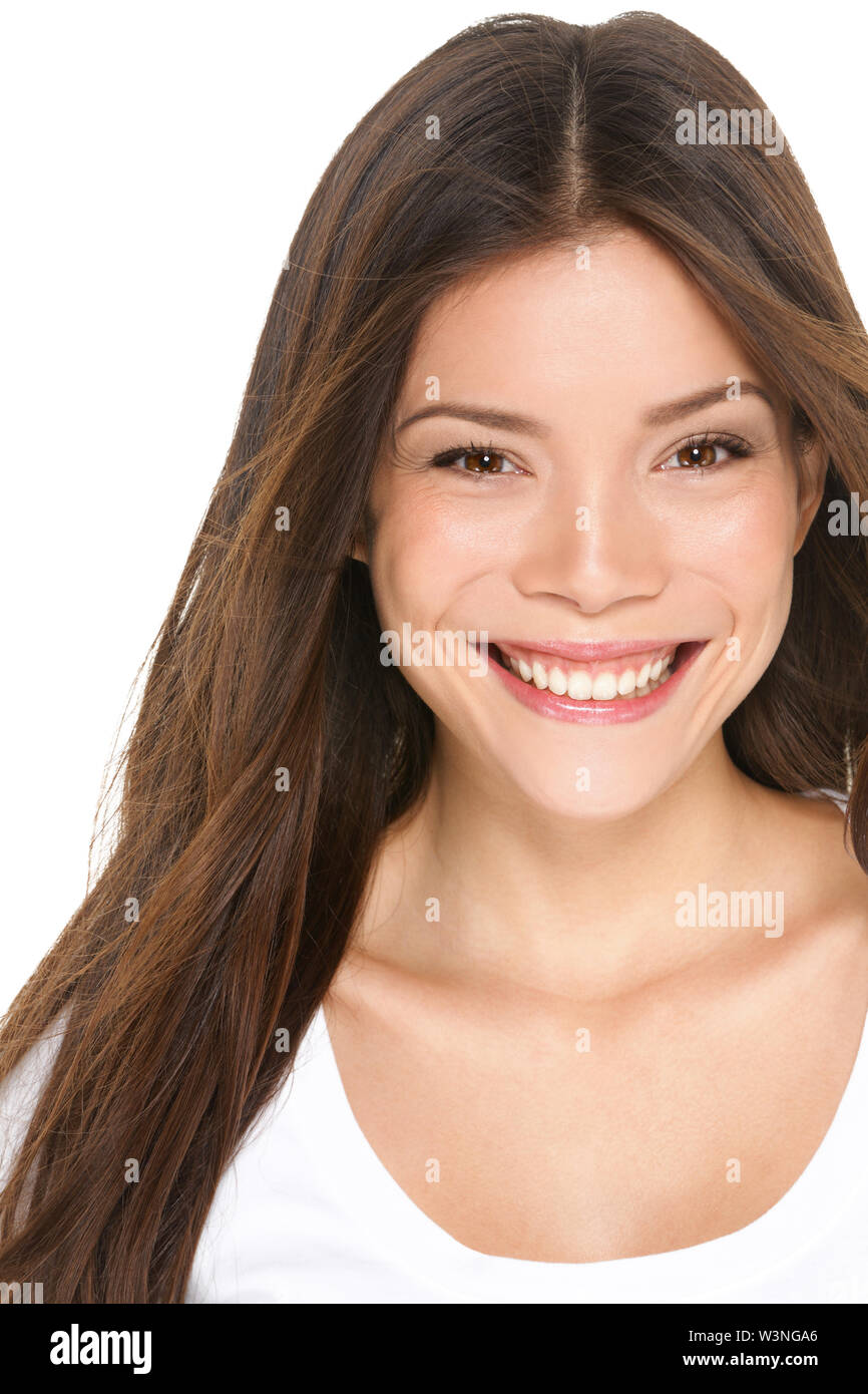 Asian woman portrait close up - Asian girl in her 20s smiling happy looking at camera isolated on white background. Beautiful female model brunette, Multi-ethnic Asian Chinese / Caucasian. Stock Photo