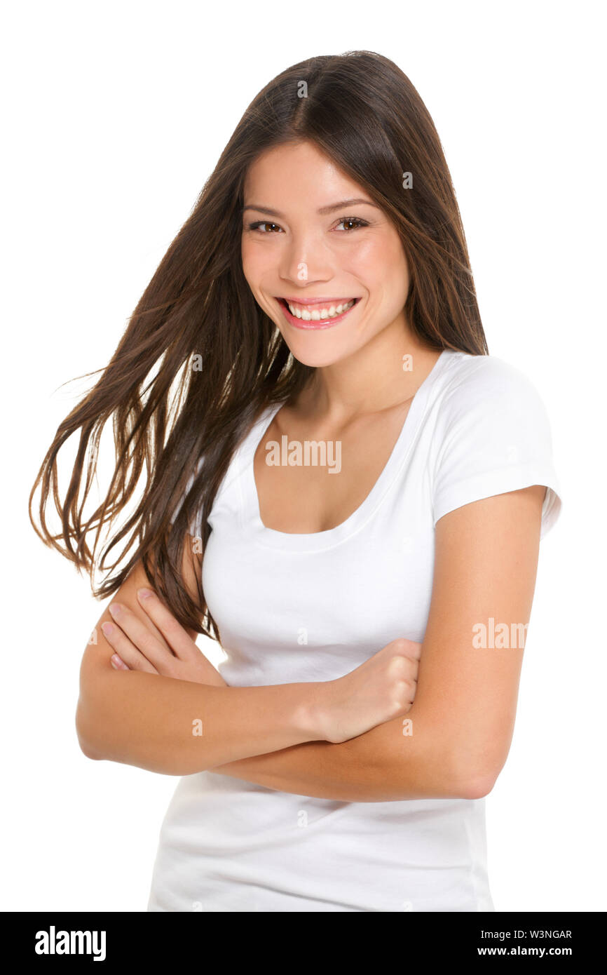 Asian woman happy candid portrait isolated on white background. Cute lovely girl looking at camera with adorable smile. Mixed race Asian Caucasian female brunette model in her twenties. Stock Photo