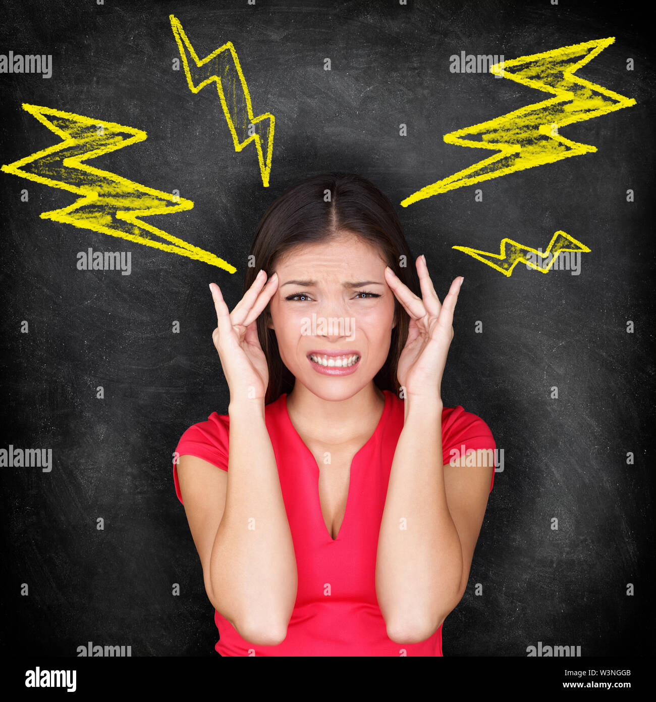 Headache - migraine and stress concept with woman with painful headache massaging temples for headache cure. Multi-ethnic Caucasian / Asian woman blackboard conceptual image. Stock Photo
