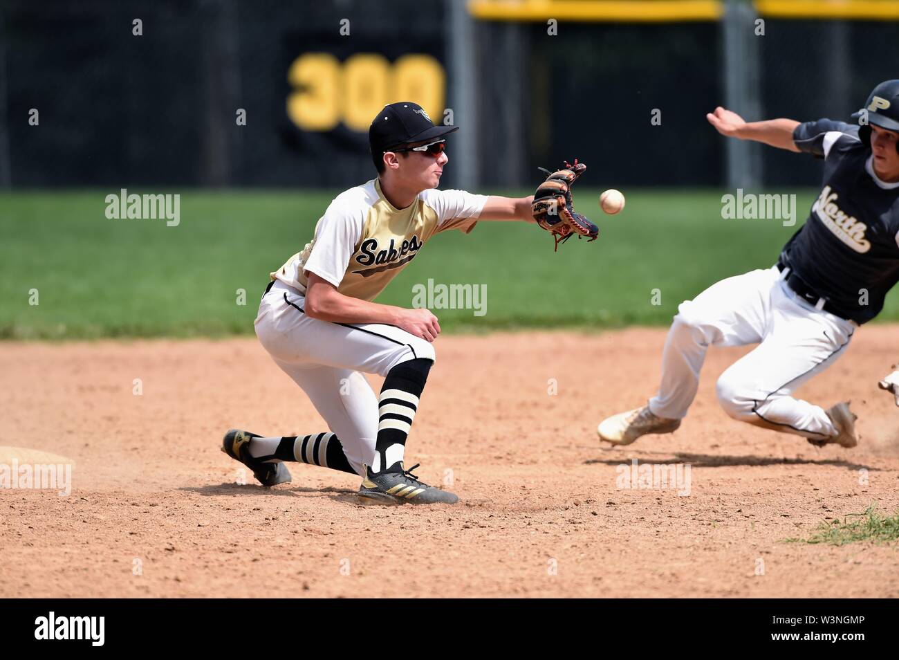 Second baseman taking a throw from the catcher in an effort to  keep the runner from stealing second base. USA Stock Photo