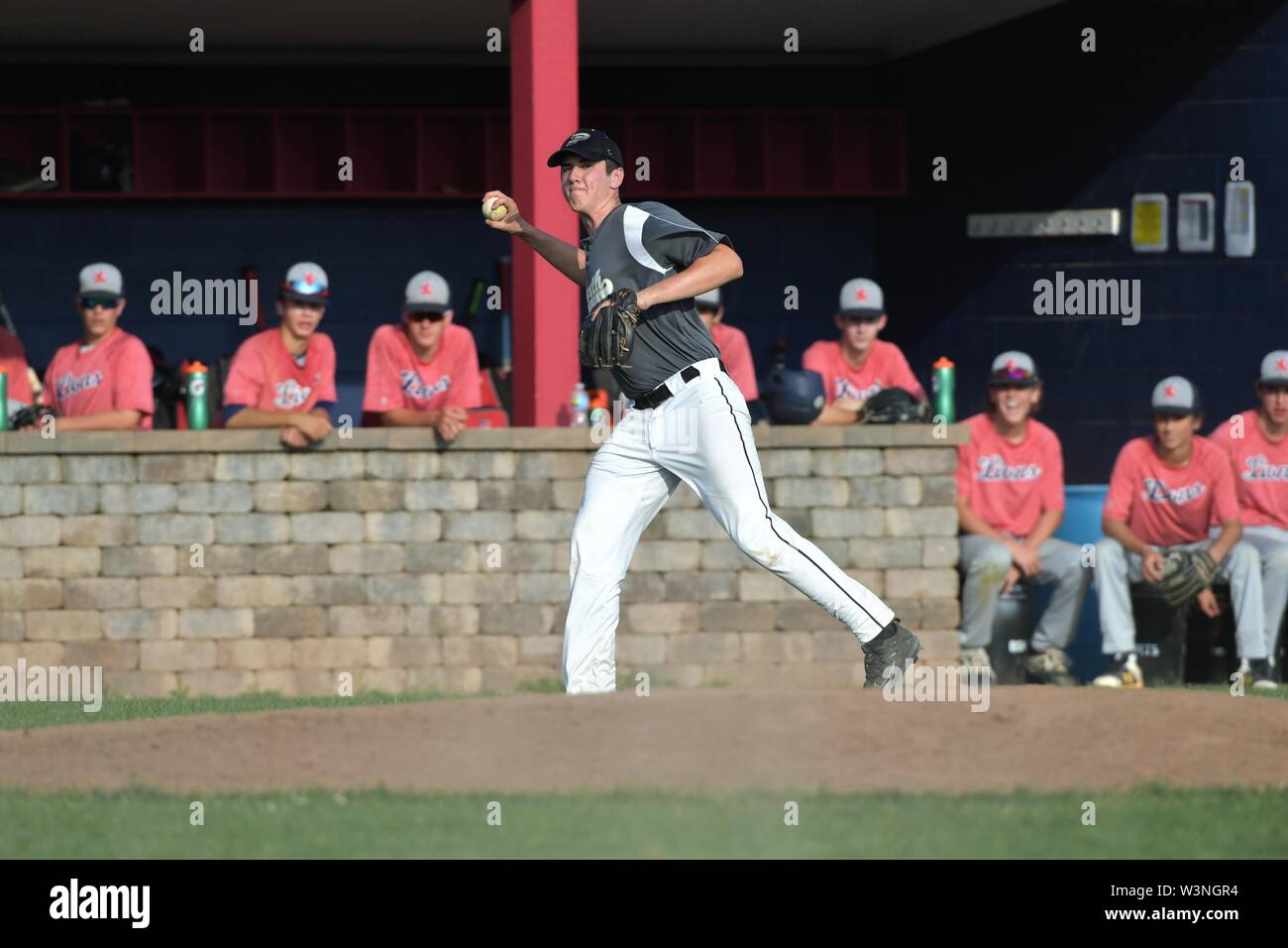 Third baseman coming up ready to throw after fielding a slowly hit