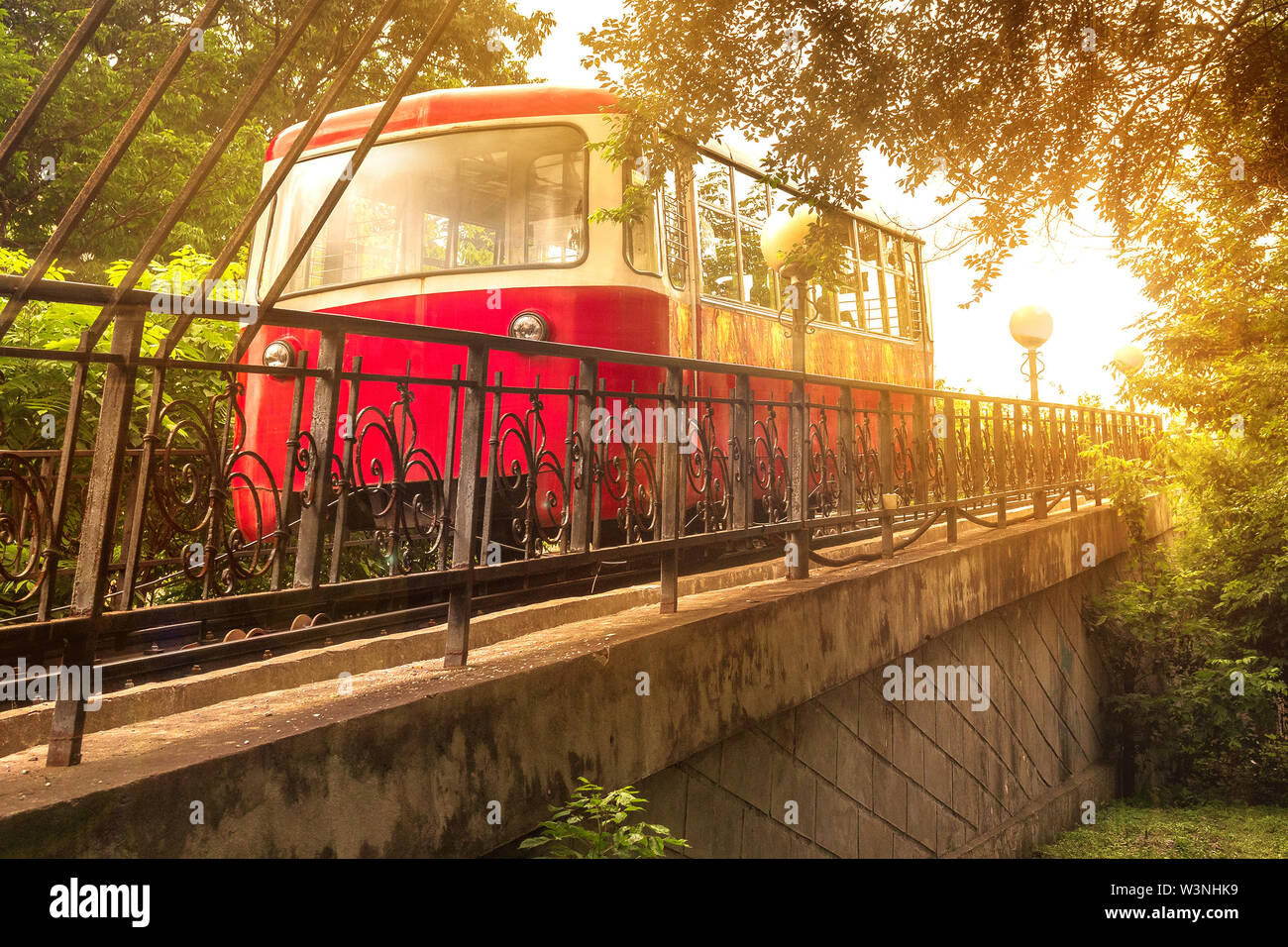The Red Car of the Funicular rises in the bright sunlight of an evening sunset in the capital of the Russian Far East, Vladivostok. Stock Photo