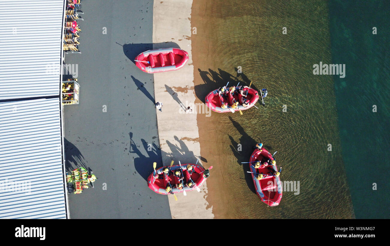Aerial top view of rafting boats with people getting ready into the river Stock Photo