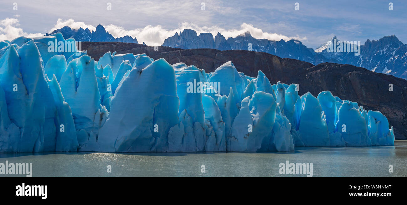 Panorama of the Grey Glacier in summer by Lago Grey with Andes peaks in the background, Torres del Paine national park, Patagonia, Chile. Stock Photo