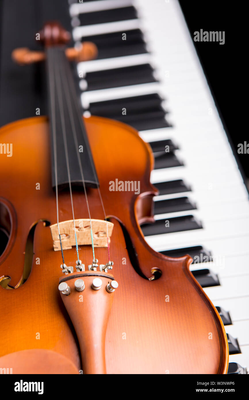 Violin on the piano on a black background Stock Photo