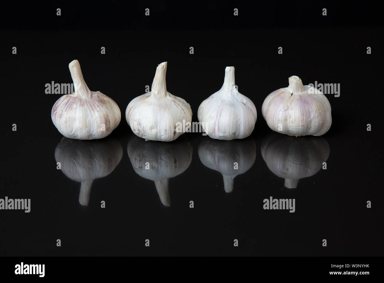 Garlic with reflection on black Stock Photo