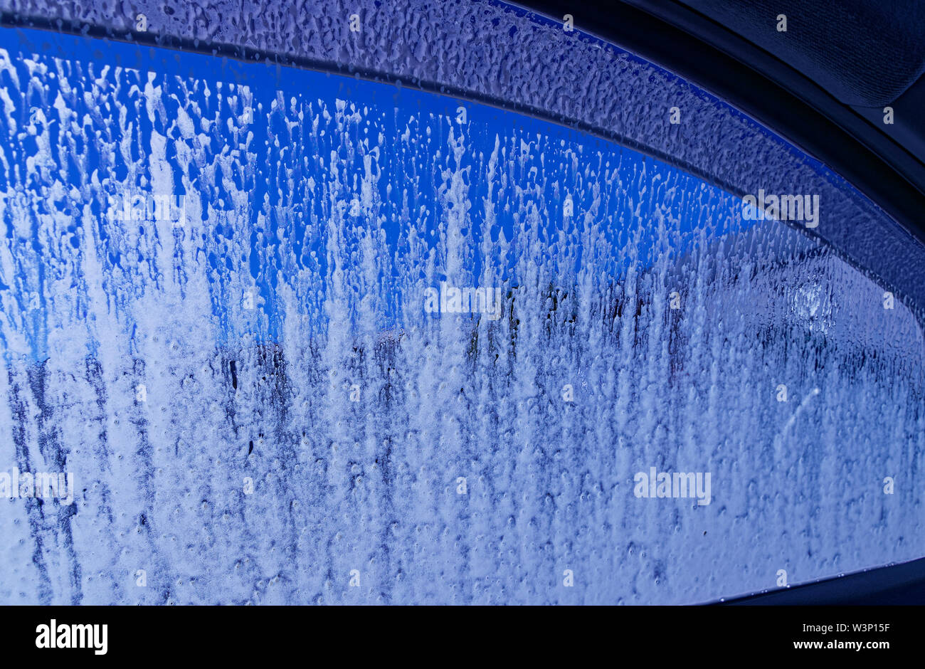 Looking out through a car window that is being washed at the car wash