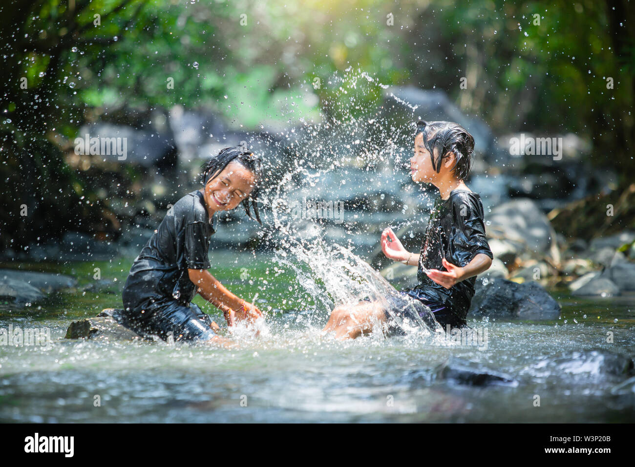 asian girl playing in the river Stock Photo - Alamy