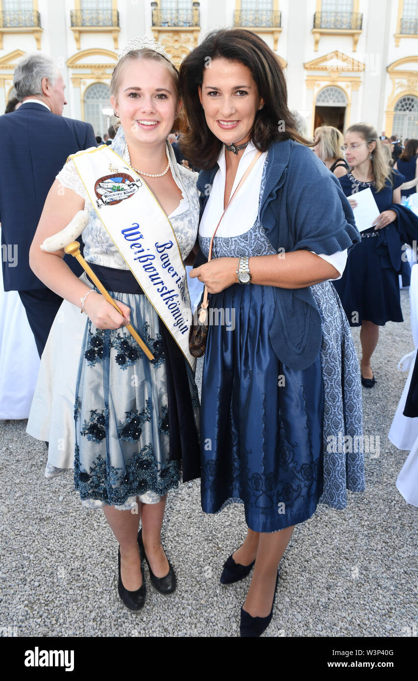 16 July 2019, Bavaria, Oberschleißheim: Michaela Kaniber (CSU), Bavaria's Minister of State for Food, Agriculture and Forestry, shows up with the Bavarian Weißwurst Queen at the summer reception of the Bavarian Parliament in front of Schleißheim Castle. About 3000 guests from all social classes are invited. Photo: Felix Hörhager/dpa Stock Photo