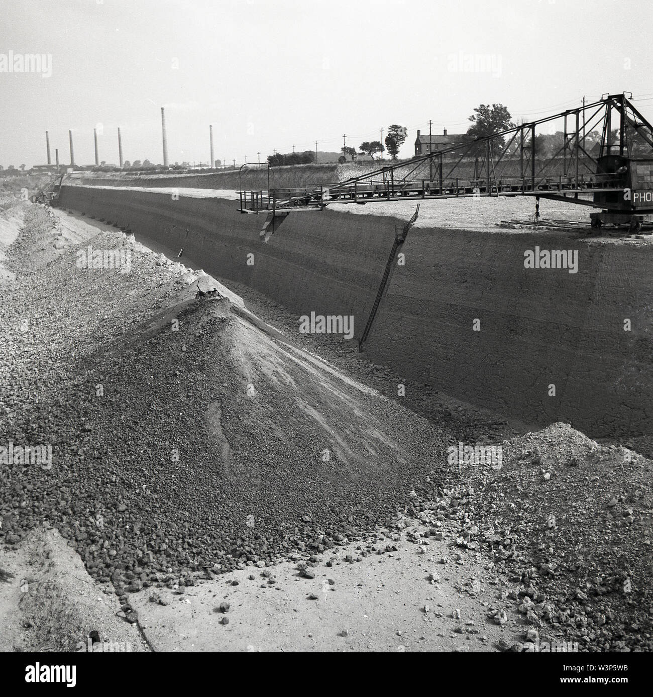 1950s, historical picture showing a large gravel or sand quarry 