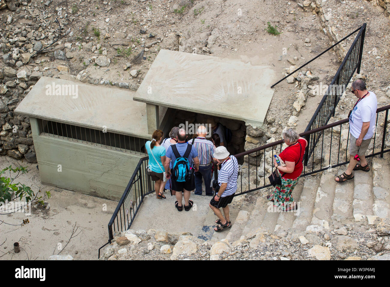% May 2018 Vistors entering the ancient underground water tunnel at excavated city Tel Meggido Israel. This place is otherwise known as Armegeddon the Stock Photo
