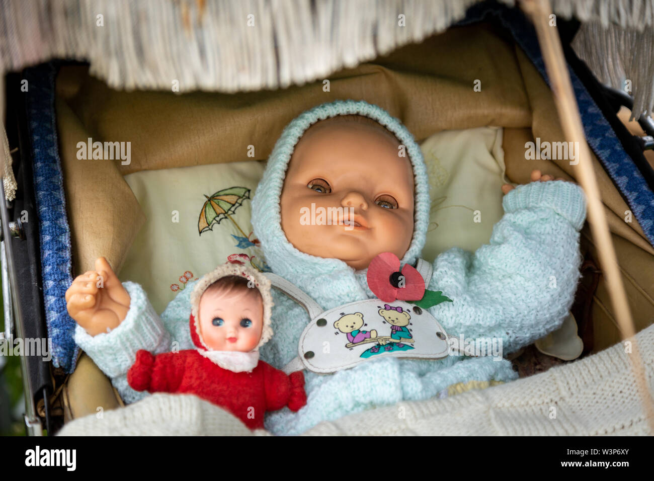 Old fashioned traditional baby doll in a pram Stock Photo