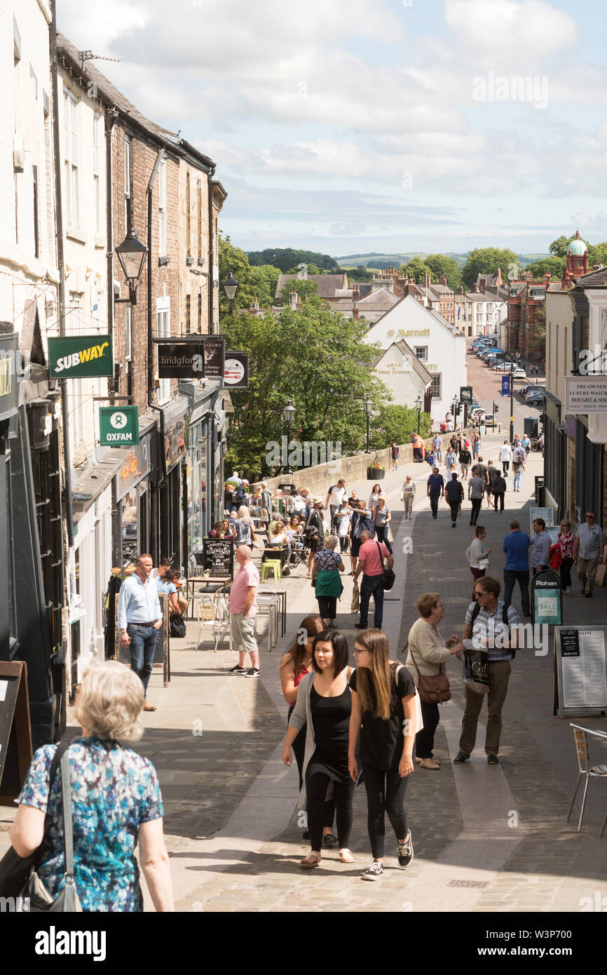 People walking through Durham city centre and across Elvet Bridge, in Co. Durham, England, UK Stock Photo