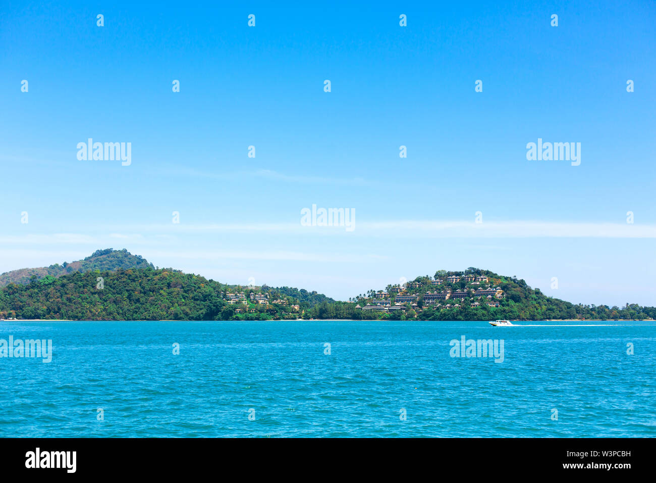 View of a green island in the blue ocean Stock Photo - Alamy