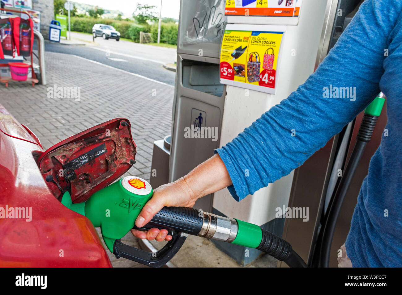 Filling car tank with unleaded petrol at Shell service station, Box, Somerset, UK Stock Photo